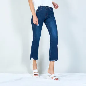 Distressed high-waisted flared jeans with raw hem wholesale