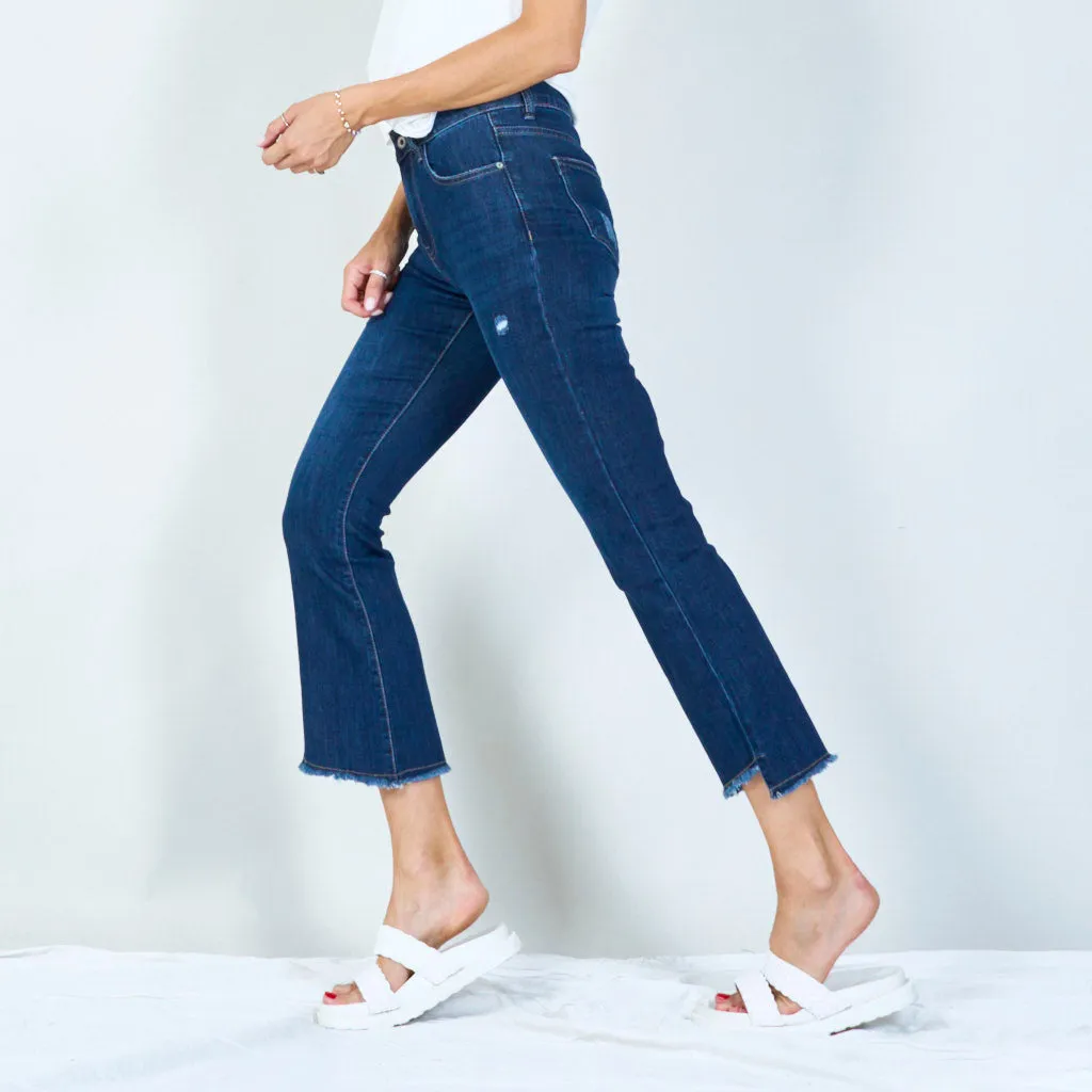 Distressed high-waisted flared jeans with raw hem wholesale