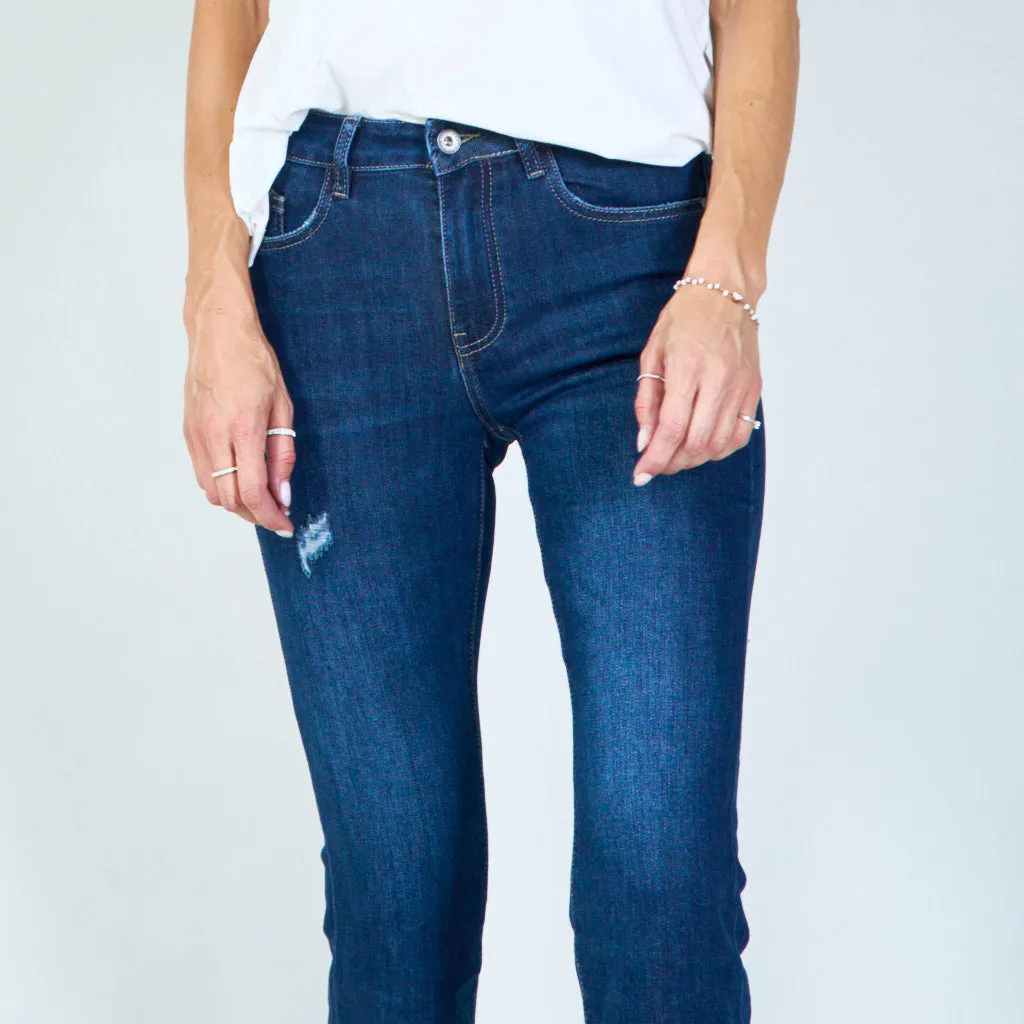 Distressed high-waisted flared jeans with raw hem wholesale