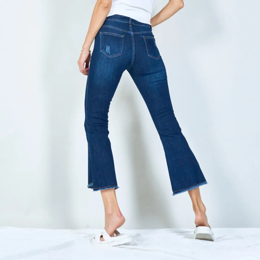 Distressed high-waisted flared jeans with raw hem wholesale